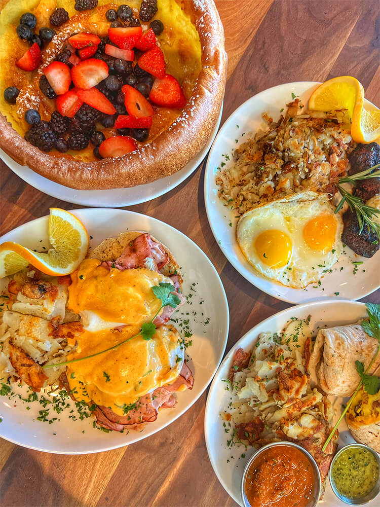 Plums Cafe brunch dishes including eggs benedict and famous Dutch baby deep dish pancake