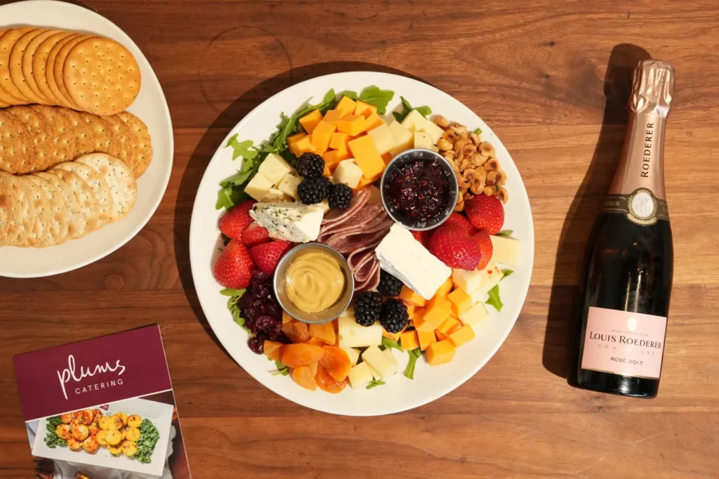 cheeseplate served with fruits, sauce and crackers