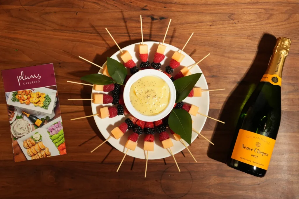 fruit skewers served with a dipping sauce